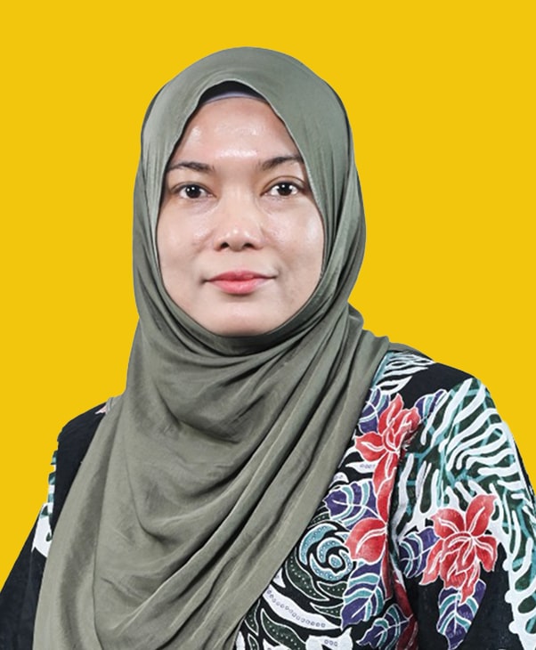 Woman in green hijab and floral top smiles gently against a yellow background, exuding warmth.