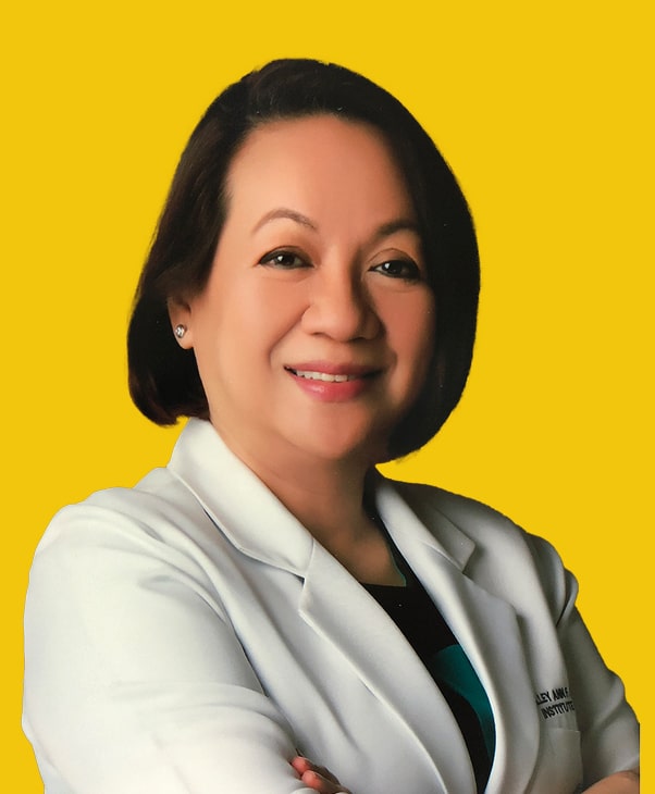 Smiling woman in white coat against yellow background, exuding warmth and professionalism.